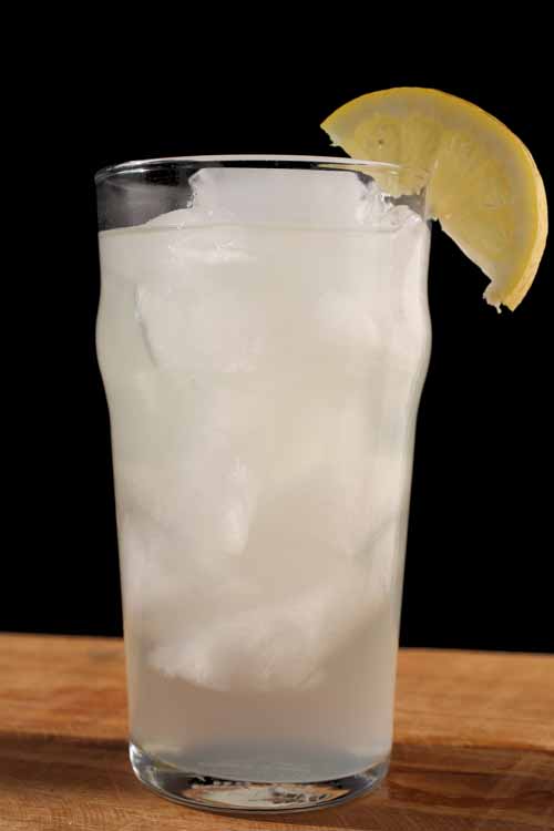 Pour over ice in glasses. Serve with a garnish with lemon and a few tablespoons of the raspberry syrup.